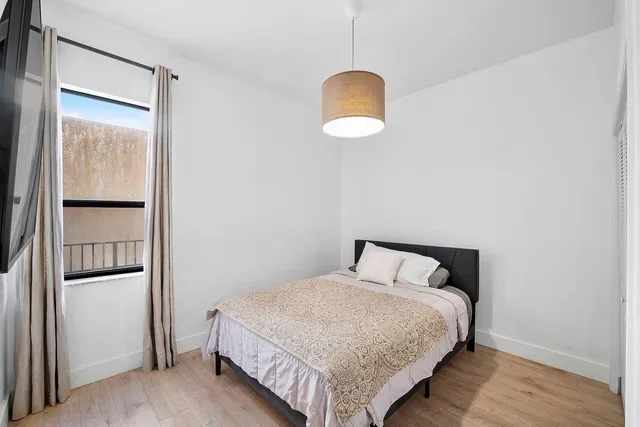 a bedroom with a bed and a table