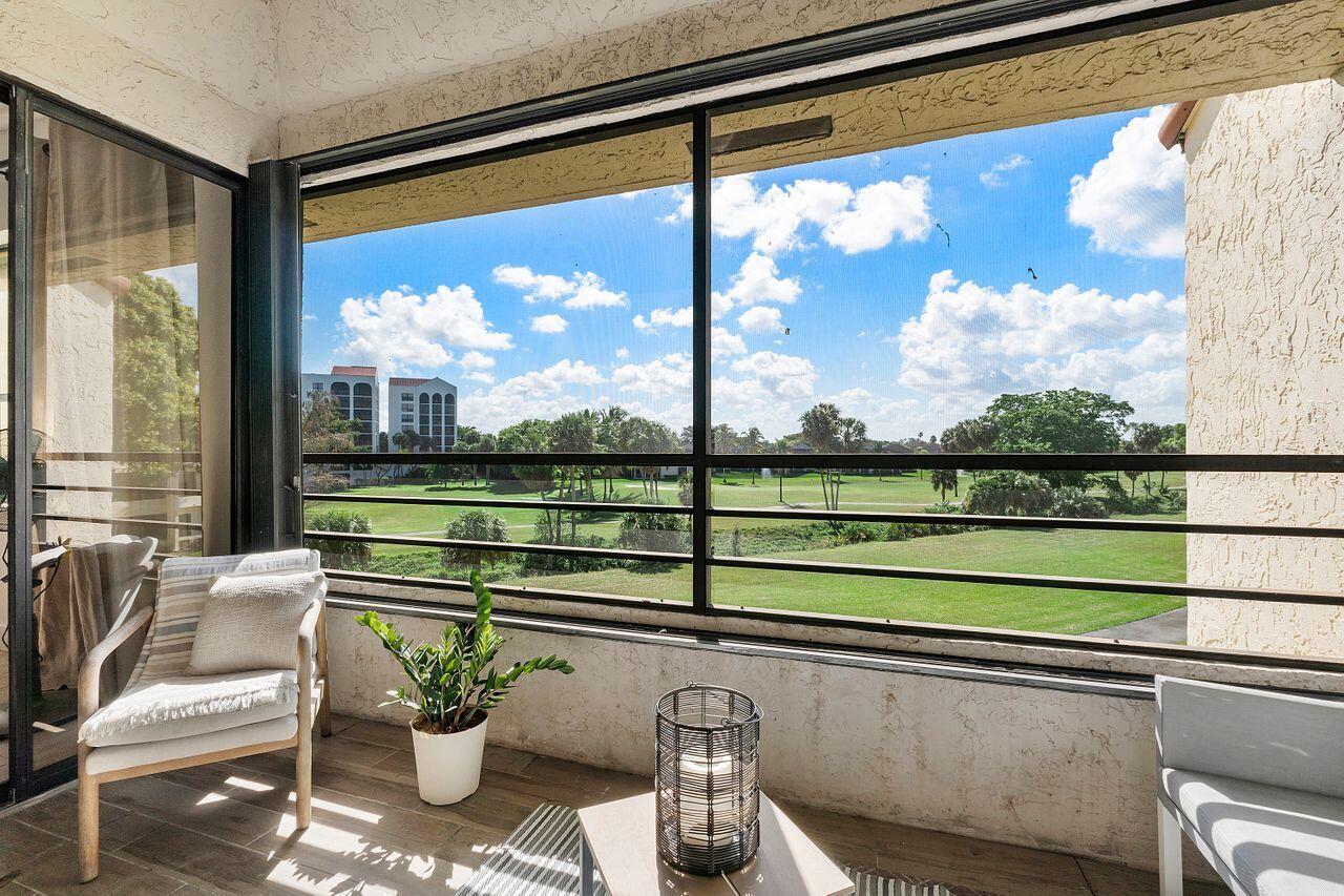 7508 La Paz Boulevard, Unit 304 Boca Raton, FL 33433 - Photo 26 of 44 a view of a floor to ceiling window next to a yard