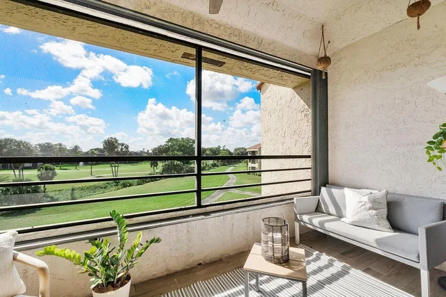 a view of a glass door with a bench