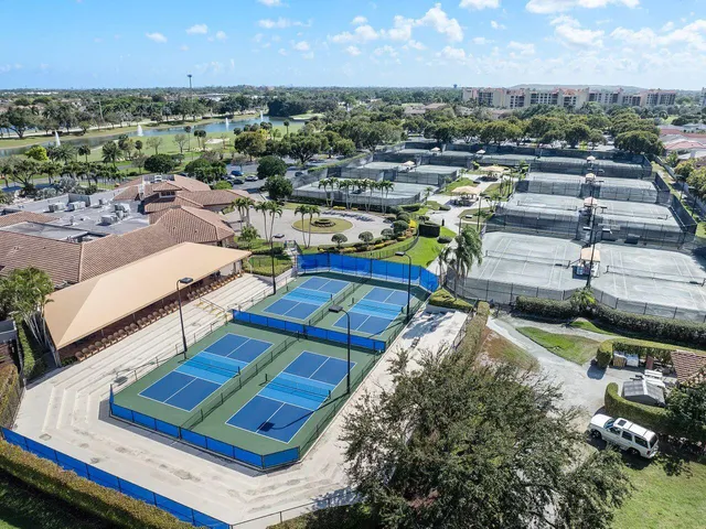 an aerial view of a house with a garden and lake view