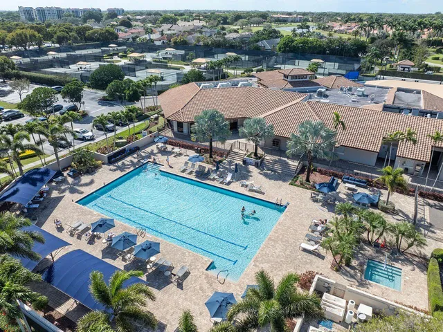 an aerial view of a resort with swimming pool and ocean view