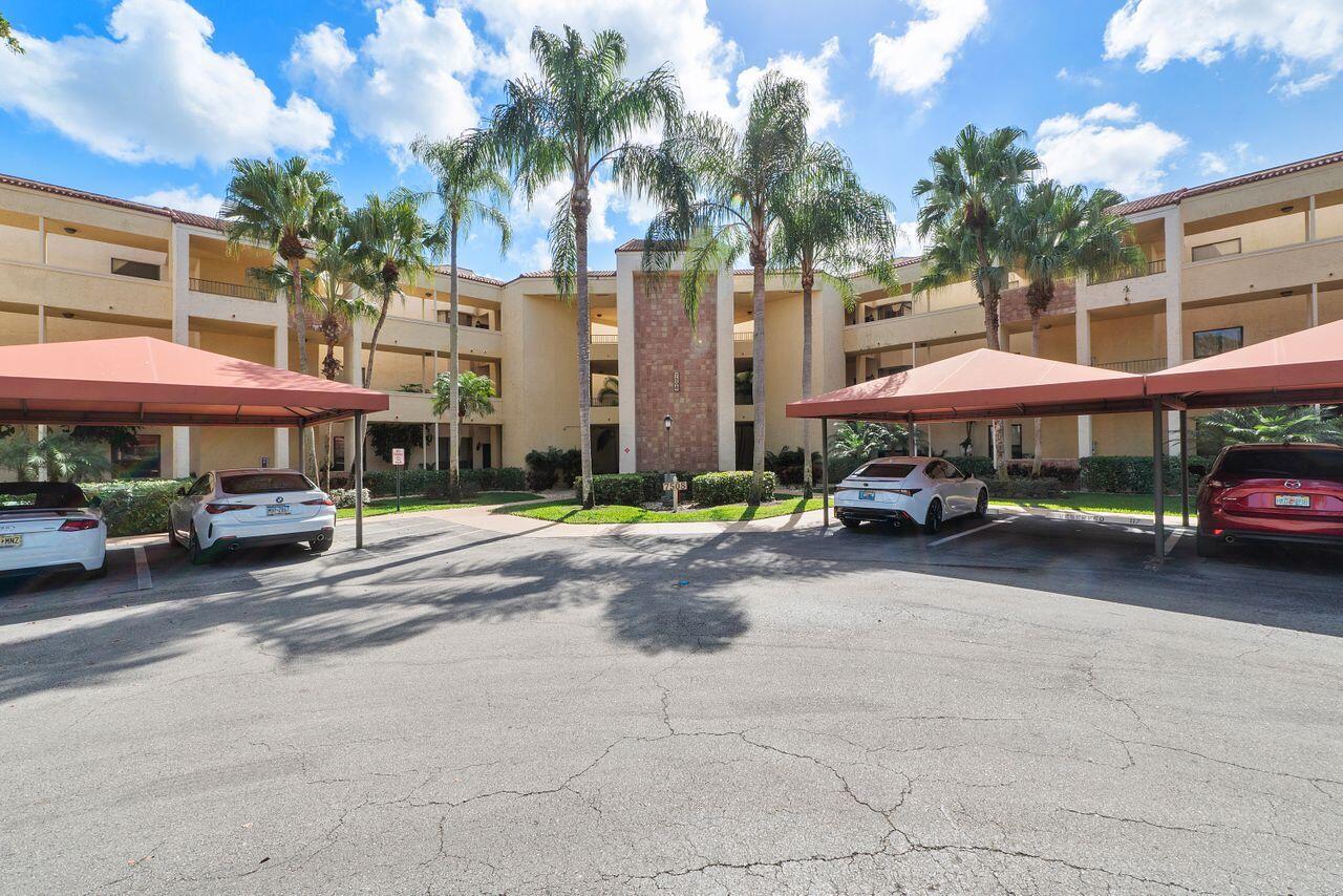 7508 La Paz Boulevard, Unit 304 Boca Raton, FL 33433 - Photo 41 of 44 a street view with building and car parked