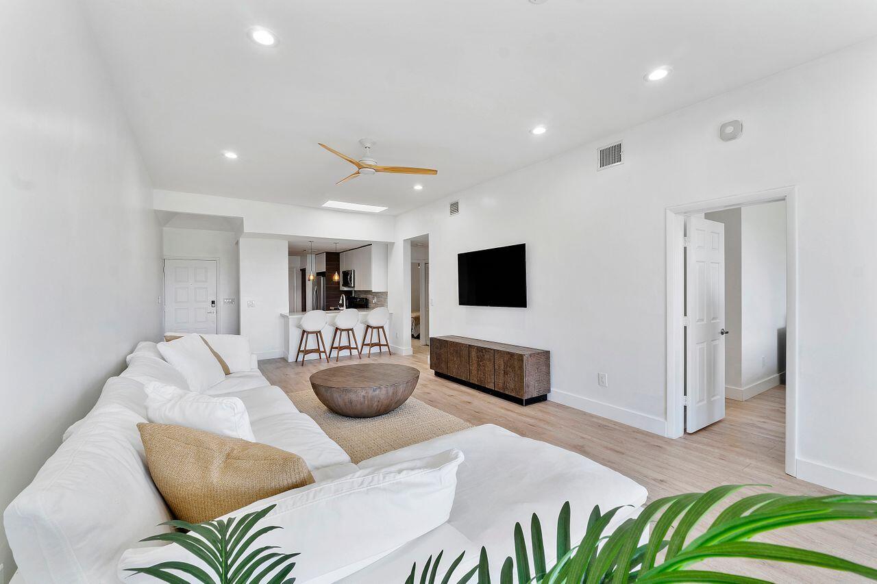 7508 La Paz Boulevard, Unit 304 Boca Raton, FL 33433 - Photo 5 of 44 a living room with furniture and a flat screen tv