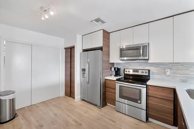 a kitchen with a refrigerator stove and microwave