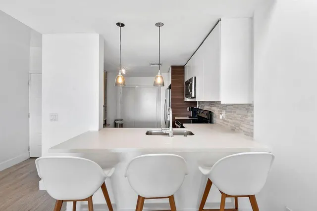 a bathroom with a sink a chair and a mirror