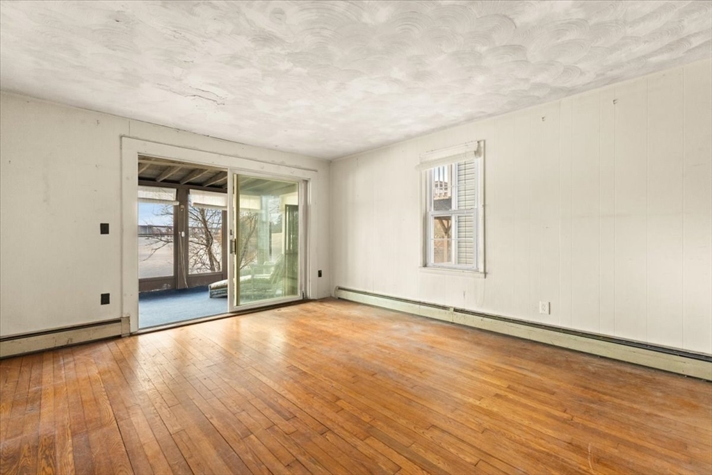 1496 Riverside Avenue Somerset, MA 02726 - Photo 15 of 40 a view of an empty room with wooden floor and a window
