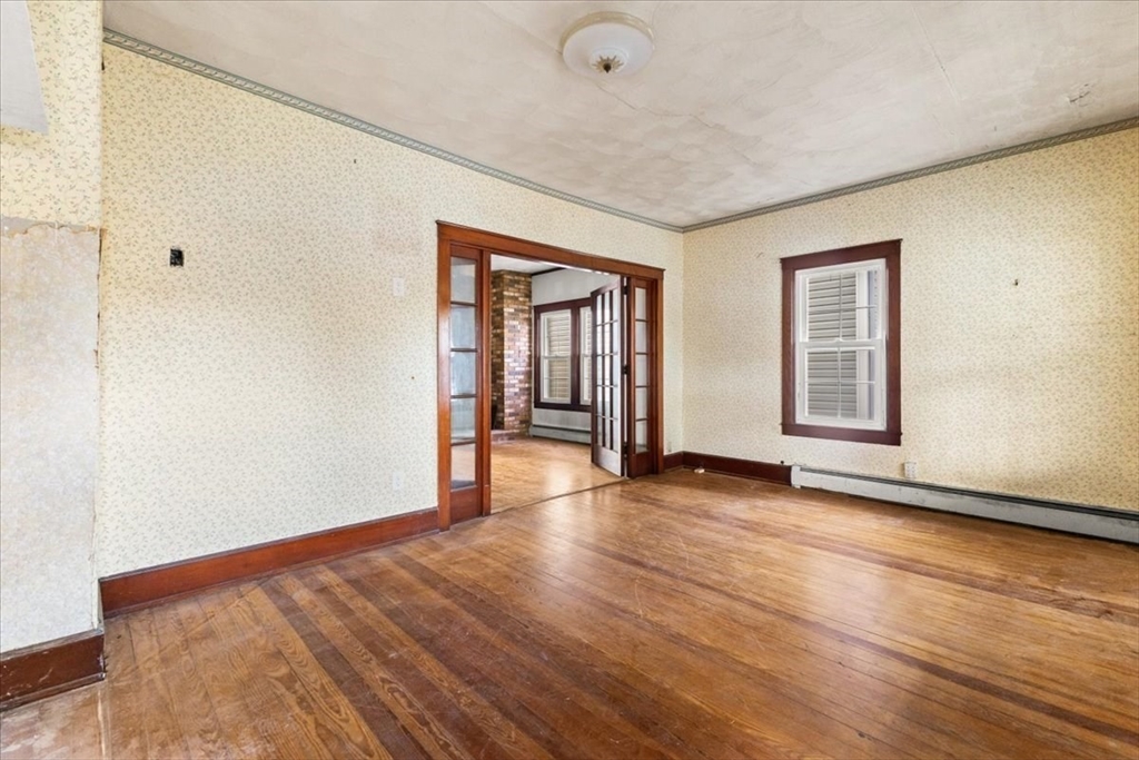 1496 Riverside Avenue Somerset, MA 02726 - Photo 23 of 40 a view of an empty room with wooden floor and a window