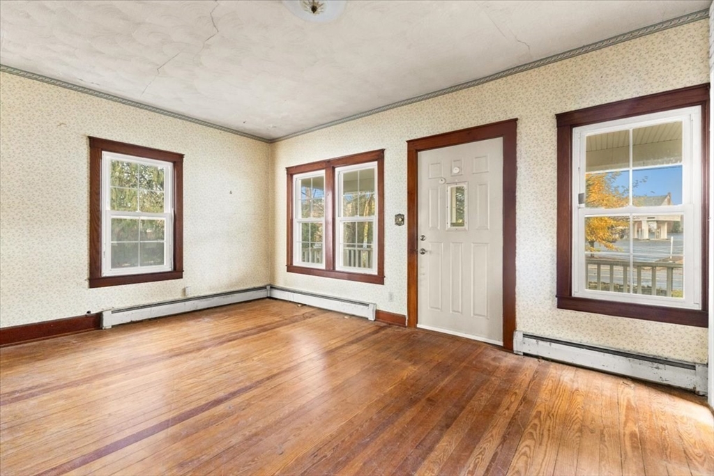 1496 Riverside Avenue Somerset, MA 02726 - Photo 24 of 40 a view of an empty room with a window and wooden floor
