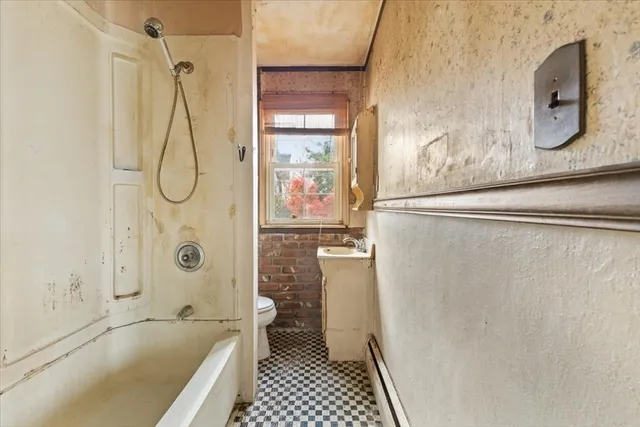a bathroom with a bathtub and a shower