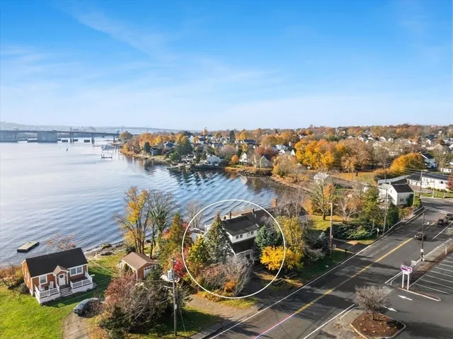 an aerial view of a house with a ocean view