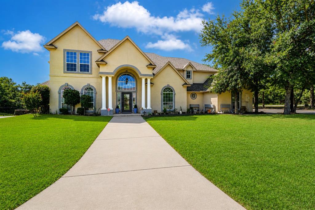 100 Manders Court Runaway Bay, TX 76426 - Photo 2 of 33 a front view of house with yard and green space