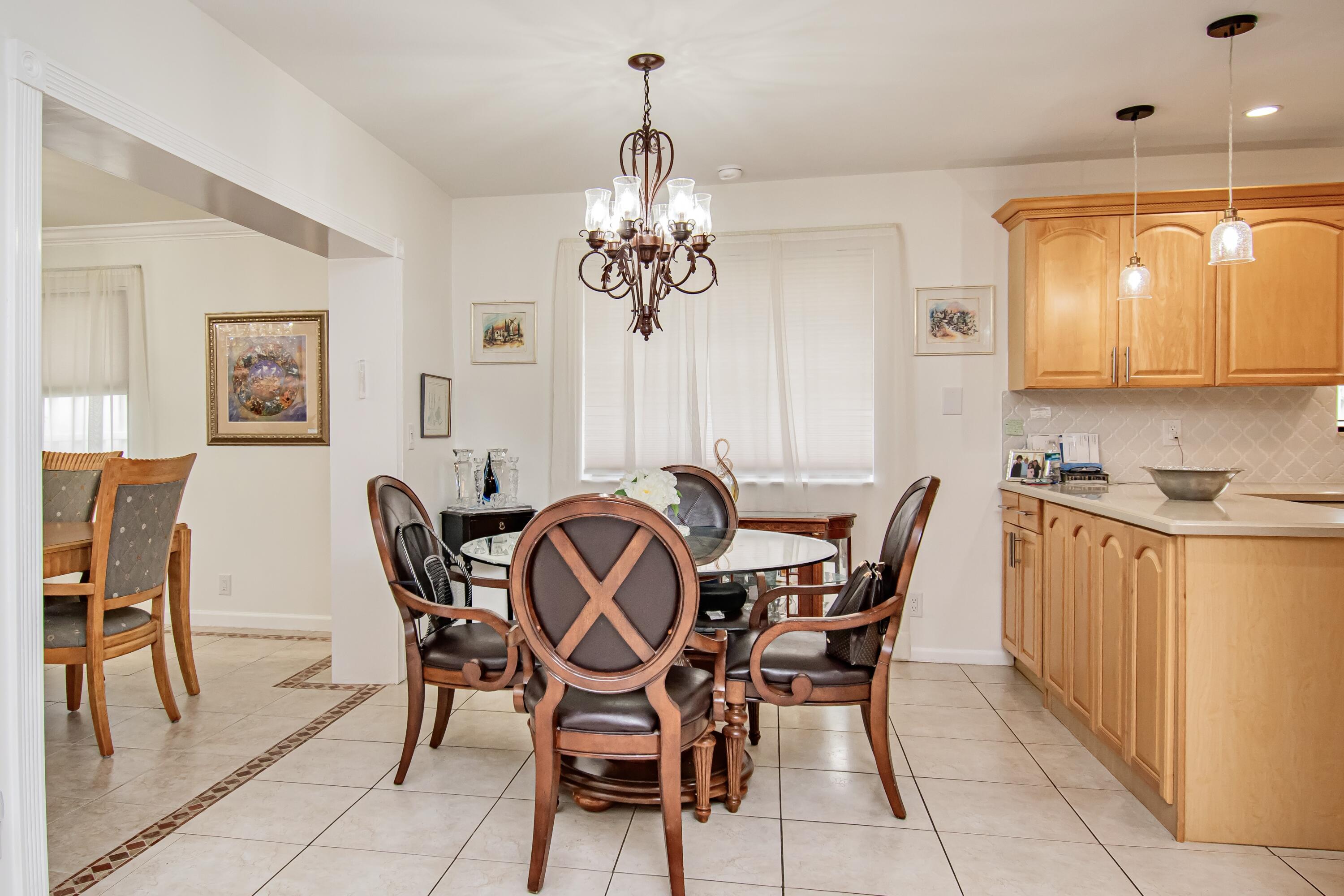 7838 Cypress Crescent Boca Raton, FL 33433 - Photo 9 of 24 a view of a dining room with furniture and a chandelier