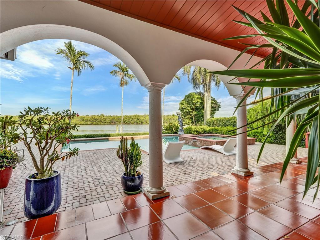 2535 Tarpon Road Naples, FL 34102 - Photo 40 of 50 Expansive waterside brick paver patio featuring a multi-level pool and integrated spa