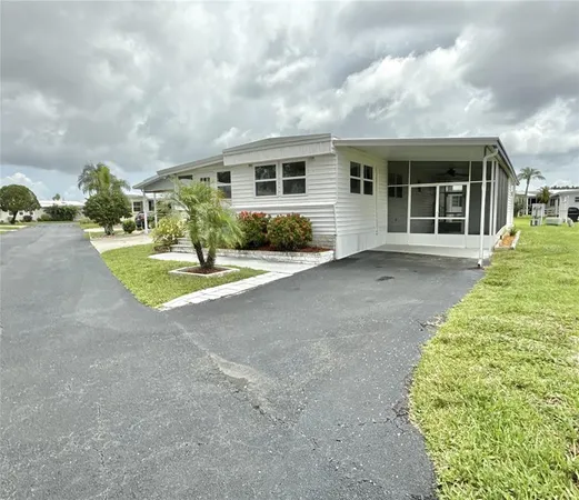 a view of a house with backyard and porch
