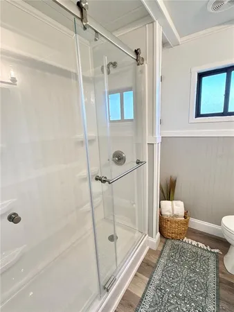 a bathroom with a tub shower vanity and a sink