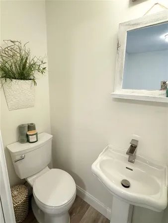 a bathroom with a sink mirror and toilet