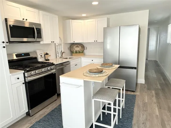 a kitchen with a sink a stove and refrigerator