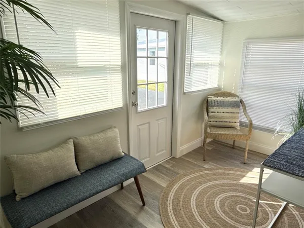a bedroom with a couch and a window