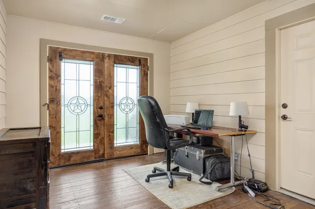 a bedroom with a bed and wooden floor