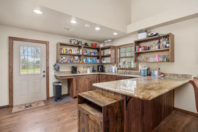 a living room with furniture a flat screen tv and a window