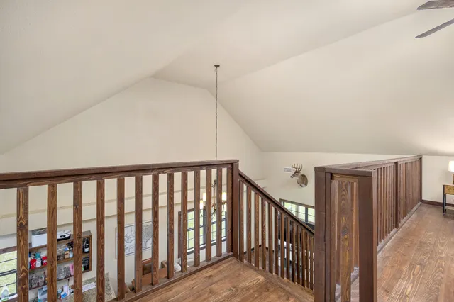 a spacious bedroom with a bed couch and ceiling fan