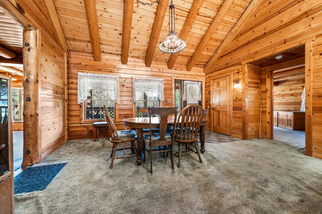 a view of a dining room with furniture and chandelier