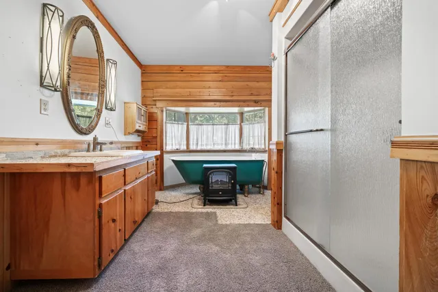 a bathroom with a sink a mirror and a window