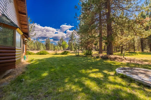 a view of a yard with swimming pool