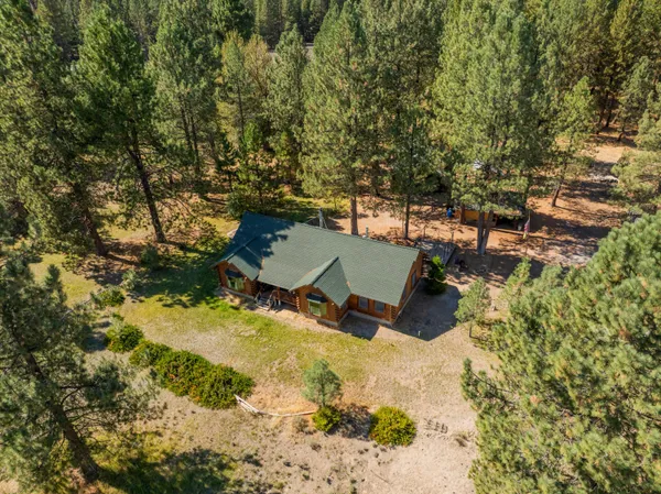 an aerial view of a house with a yard