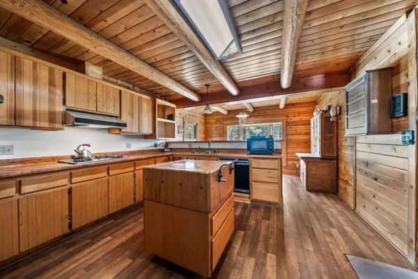 a kitchen with stainless steel appliances granite countertop a sink and wooden cabinets
