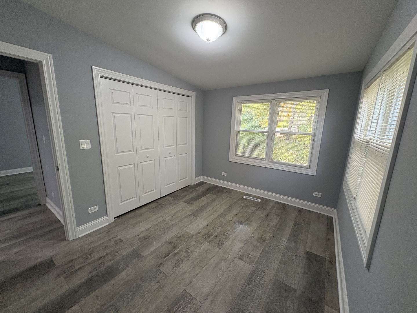 5517 Essex Road Lisle, IL 60532 - Photo 14 of 19 an empty room with window and wooden floor