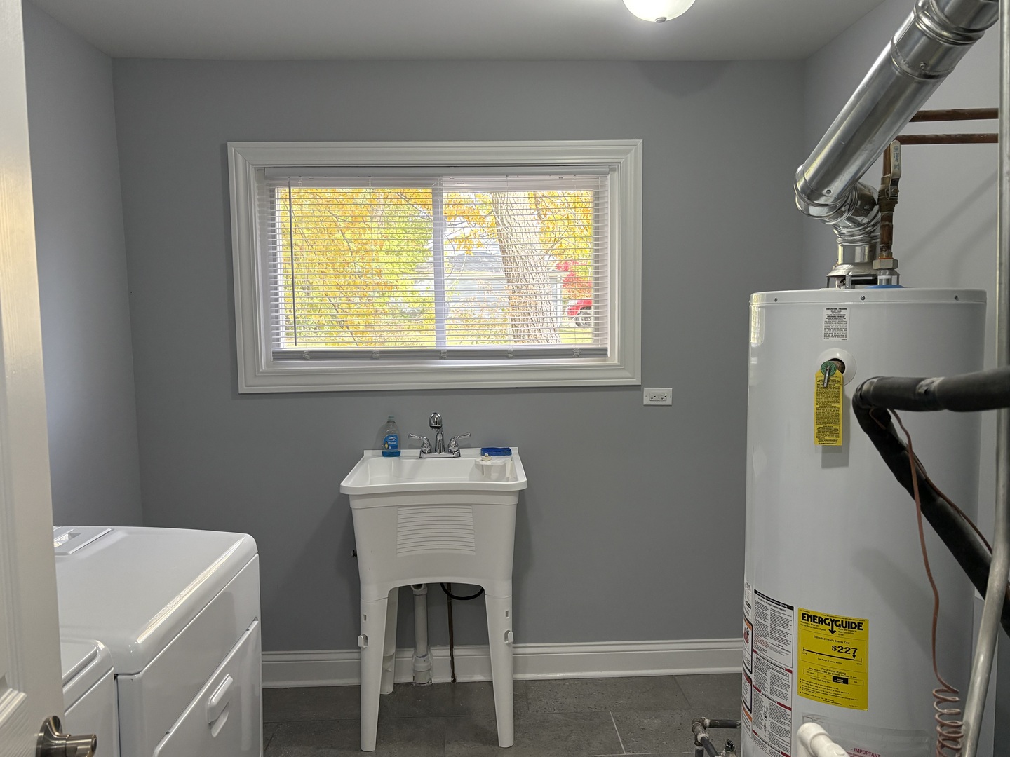 5517 Essex Road Lisle, IL 60532 - Photo 16 of 19 a bathroom with a sink a bathtub and a window