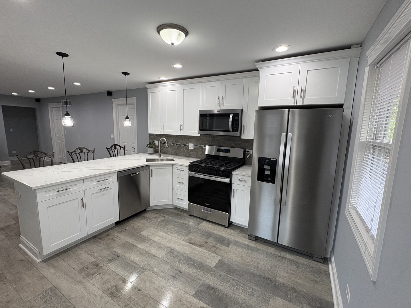 5517 Essex Road Lisle, IL 60532 - Photo 3 of 19 a kitchen with a white refrigerator freezer a sink and a stove