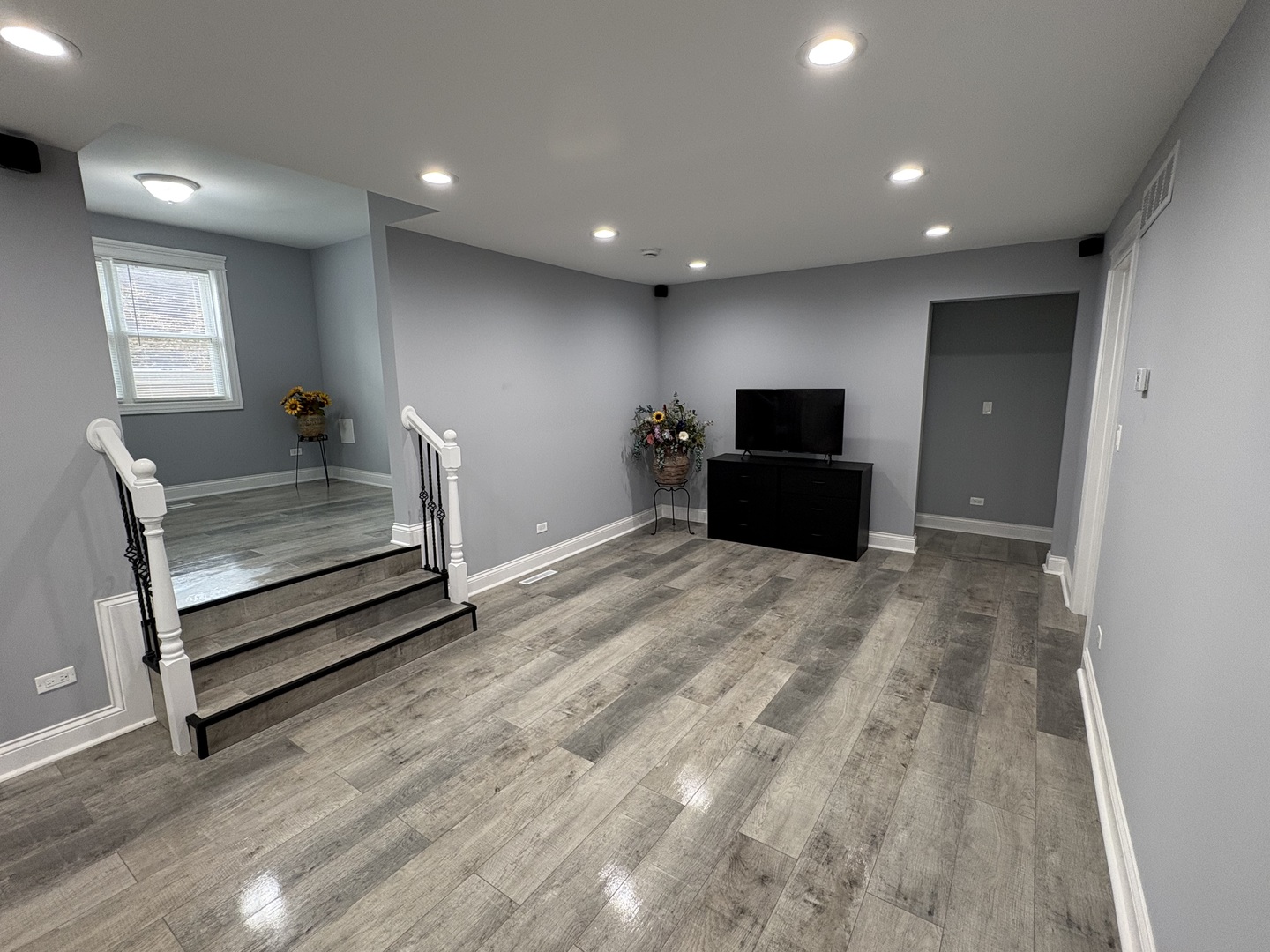 5517 Essex Road Lisle, IL 60532 - Photo 5 of 19 a view of hallway with stairs and wooden floor