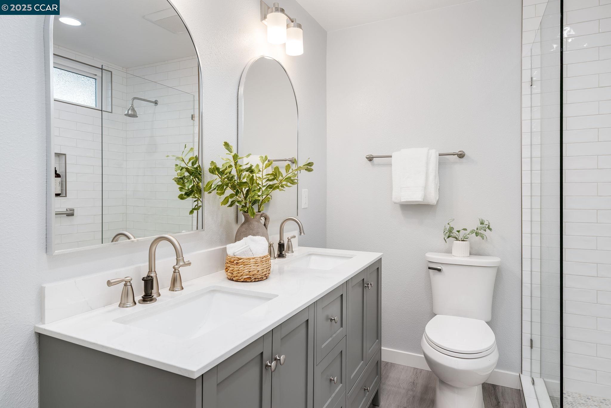 2828 Aptos Way San Ramon, CA 94583 - Photo 25 of 38 a bathroom with a toilet sink and mirror