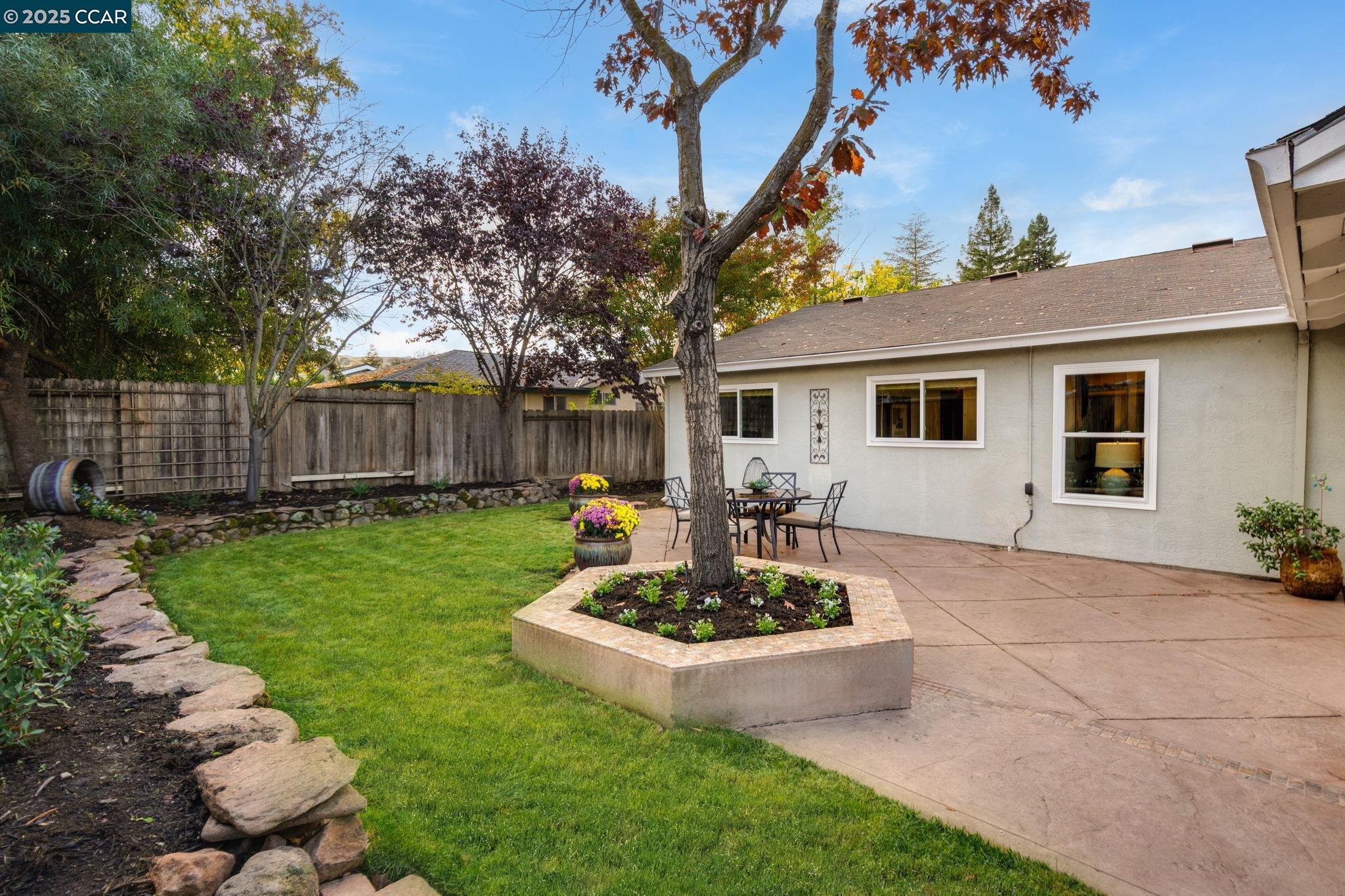 2828 Aptos Way San Ramon, CA 94583 - Photo 29 of 38 a view of a backyard with table and chairs potted plants and large tree