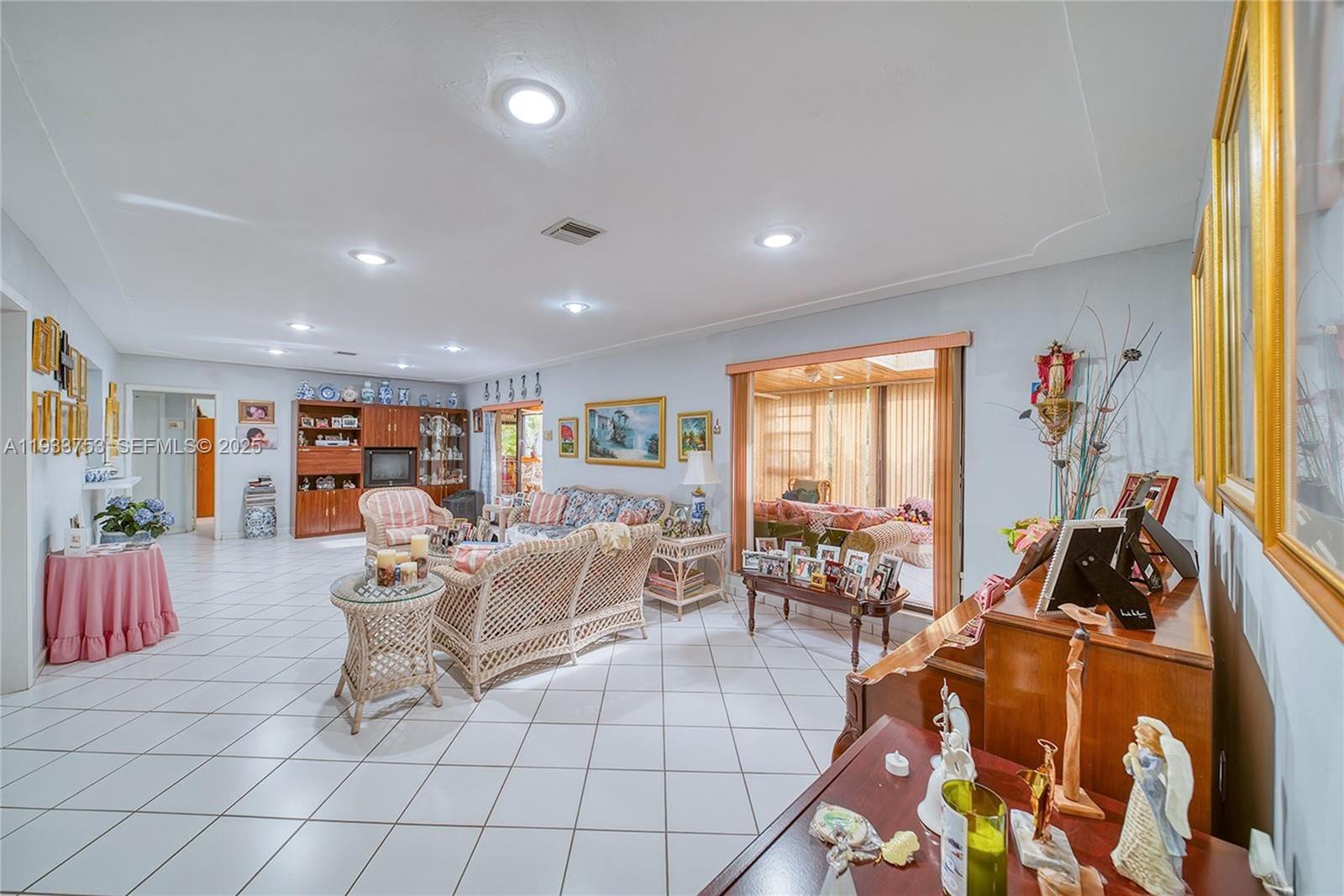 3585 Southwest 107th Court Miami, FL 33165 - Photo 12 of 45 a living room with furniture and a large window