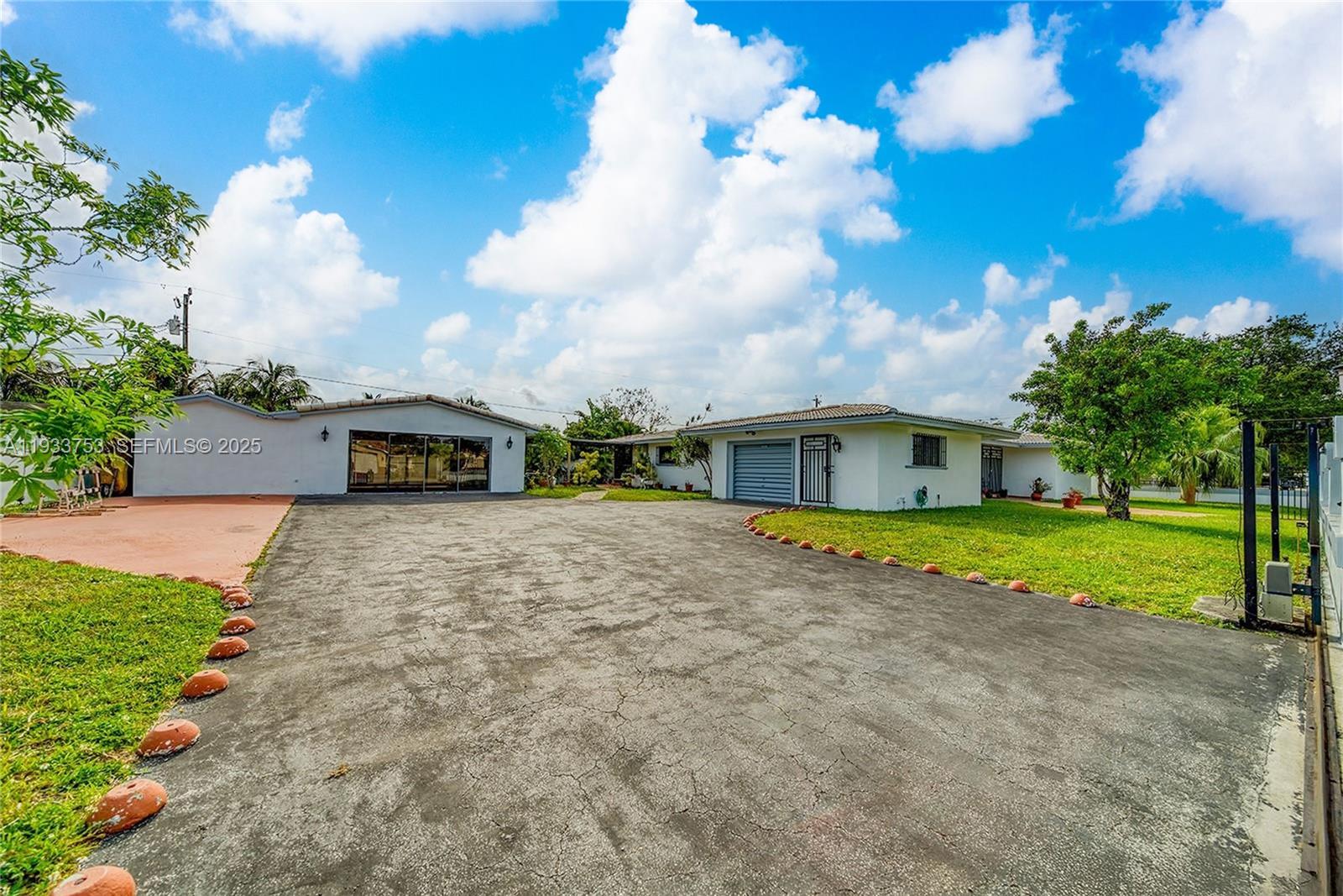 3585 Southwest 107th Court Miami, FL 33165 - Photo 4 of 45 a front view of house with yard and trees