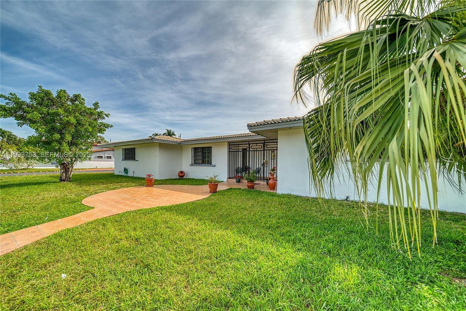 3585 Southwest 107th Court Miami, FL 33165 - Photo 8 of 45 a front view of house with yard and outdoor seating