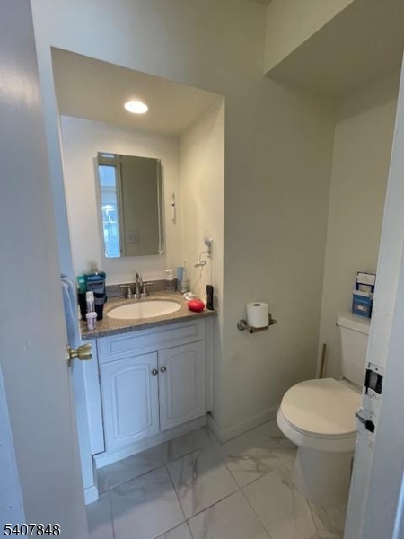 1 Carriage Way, Unit 8 Montclair, NJ 07042 - Photo 12 of 26 a bathroom with a sink a toilet and mirror