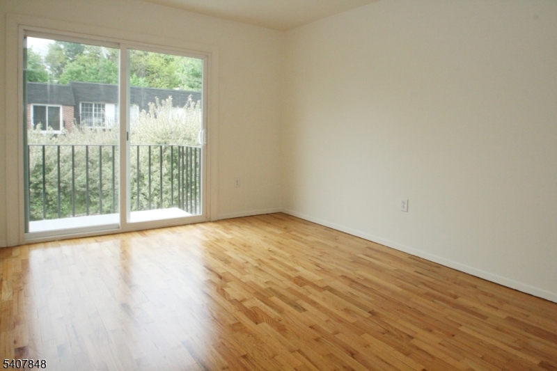 1 Carriage Way, Unit 8 Montclair, NJ 07042 - Photo 14 of 26 a view of an empty room with wooden floor and a window