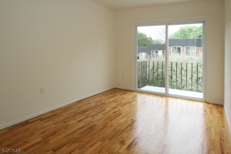 1 Carriage Way, Unit 8 Montclair, NJ 07042 - Photo 18 of 26 a view of an empty room with wooden floor and a window