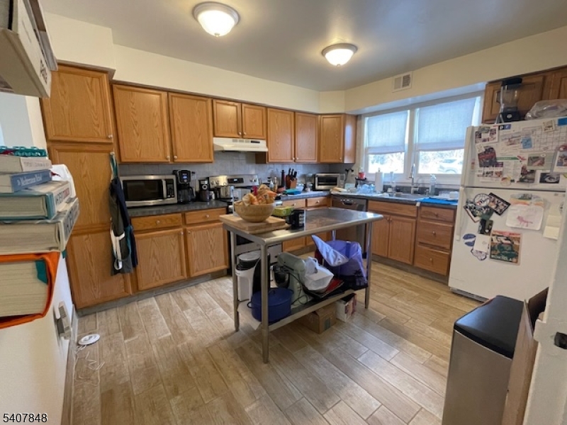 1 Carriage Way, Unit 8 Montclair, NJ 07042 - Photo 3 of 26 a kitchen with sink cabinets and wooden floor