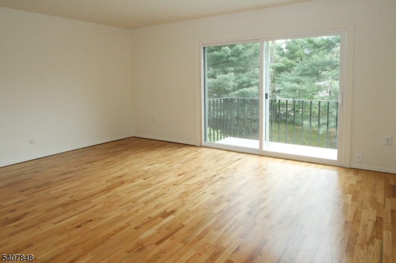 1 Carriage Way, Unit 8 Montclair, NJ 07042 - Photo 9 of 26 a view of an empty room with wooden floor and a window