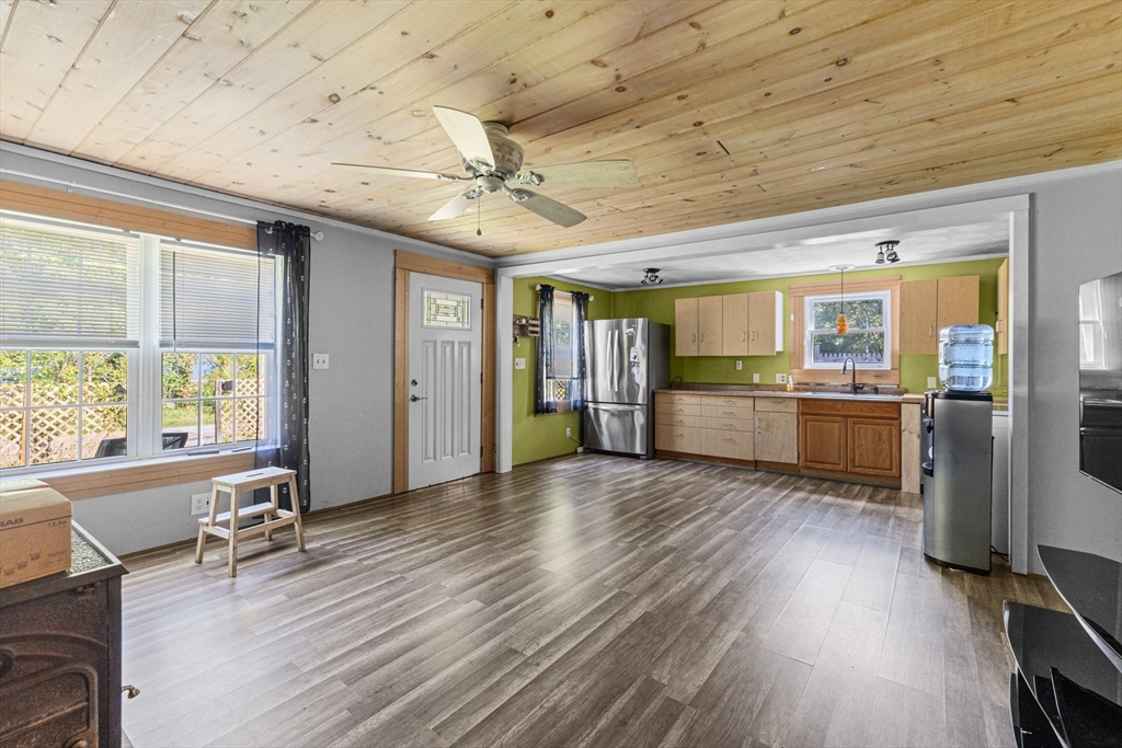 15 Morrison Way Lakeville, MA 02347 - Photo 15 of 26 a view of a livingroom with furniture wooden floor a ceiling fan and windows