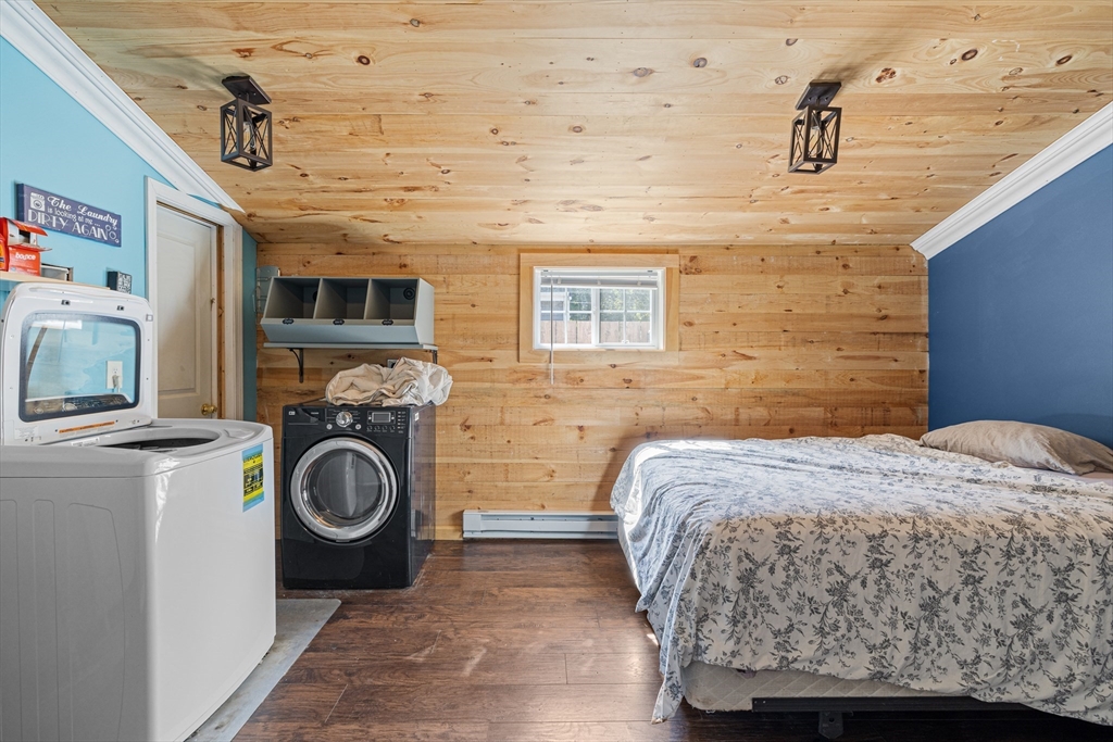 15 Morrison Way Lakeville, MA 02347 - Photo 18 of 26 a bedroom with a bed and a washing machine in it