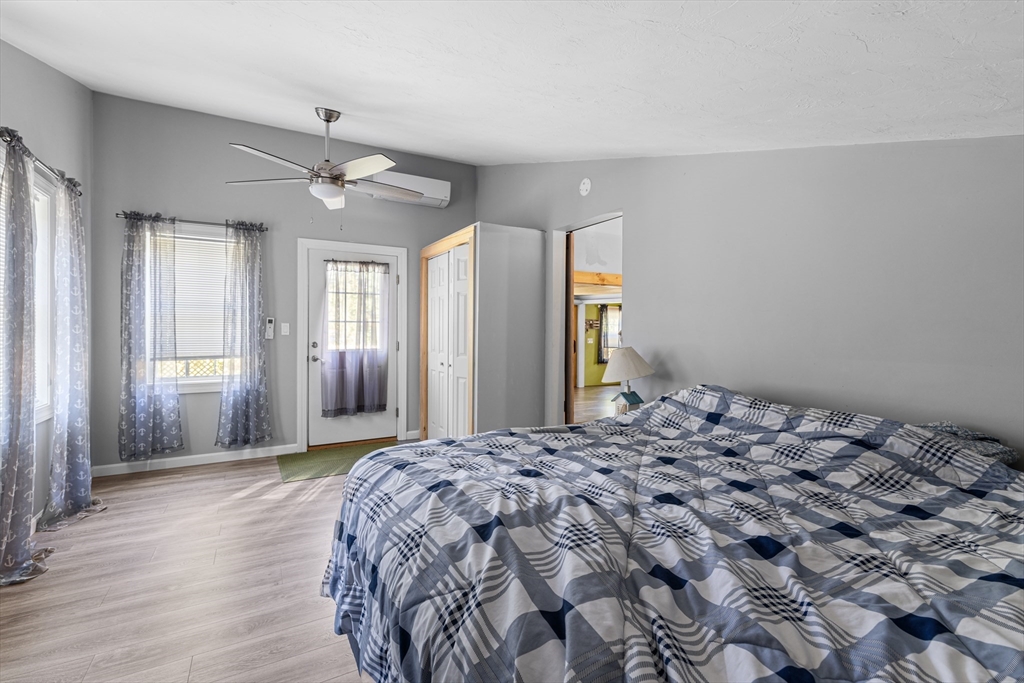 15 Morrison Way Lakeville, MA 02347 - Photo 20 of 26 a bedroom with a large bed dresser and a window