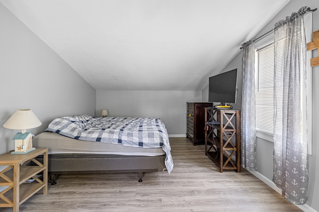 15 Morrison Way Lakeville, MA 02347 - Photo 21 of 26 a bedroom with a bed and a flat tv screen on a dresser