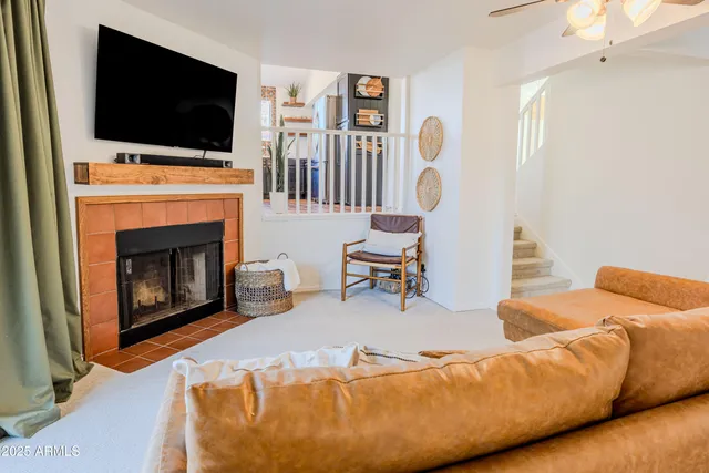 a living room with furniture fireplace and flat screen tv