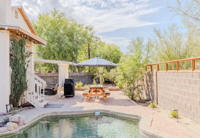 a small pool with an outdoor seating